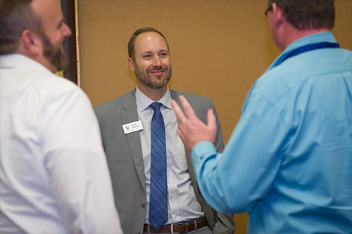 A photo of Steve Clemens speaking with insurance agents.